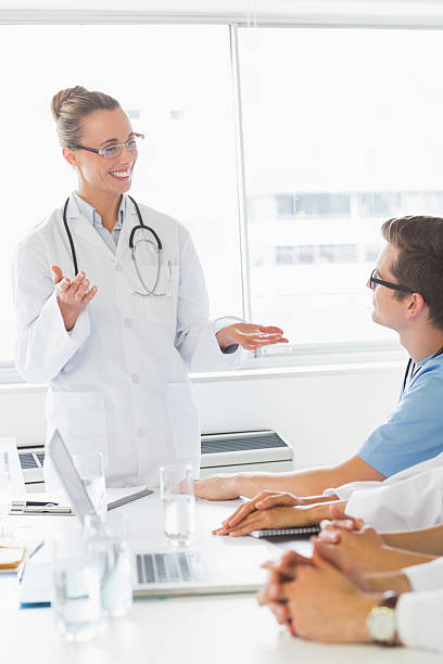 istock Happy doctor discussing with colleagues 465046286