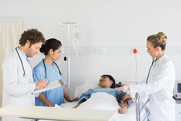 istock Medical team examining patient 465046636