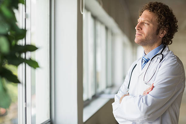 Thoughtful male doctor stock photo