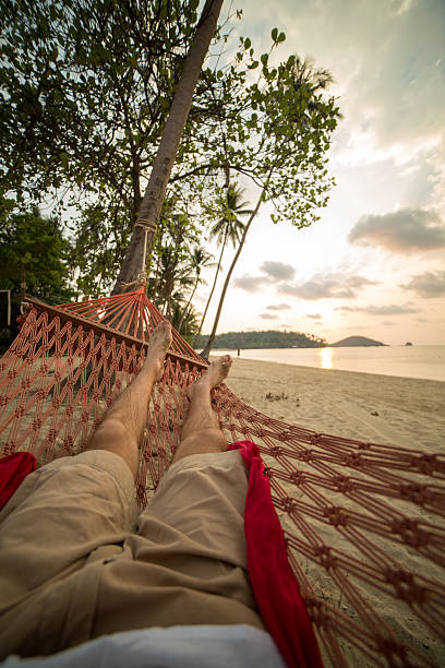 istock Man relaxing on hammock on tropical Island 465047458