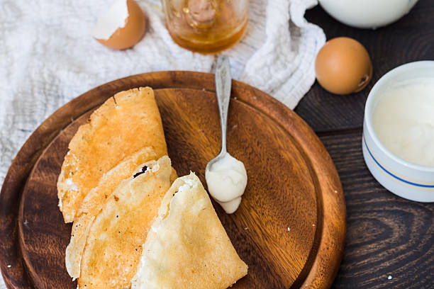 istock thin pancakes with cottage cheese, prunes, honey and sour cream 465047546