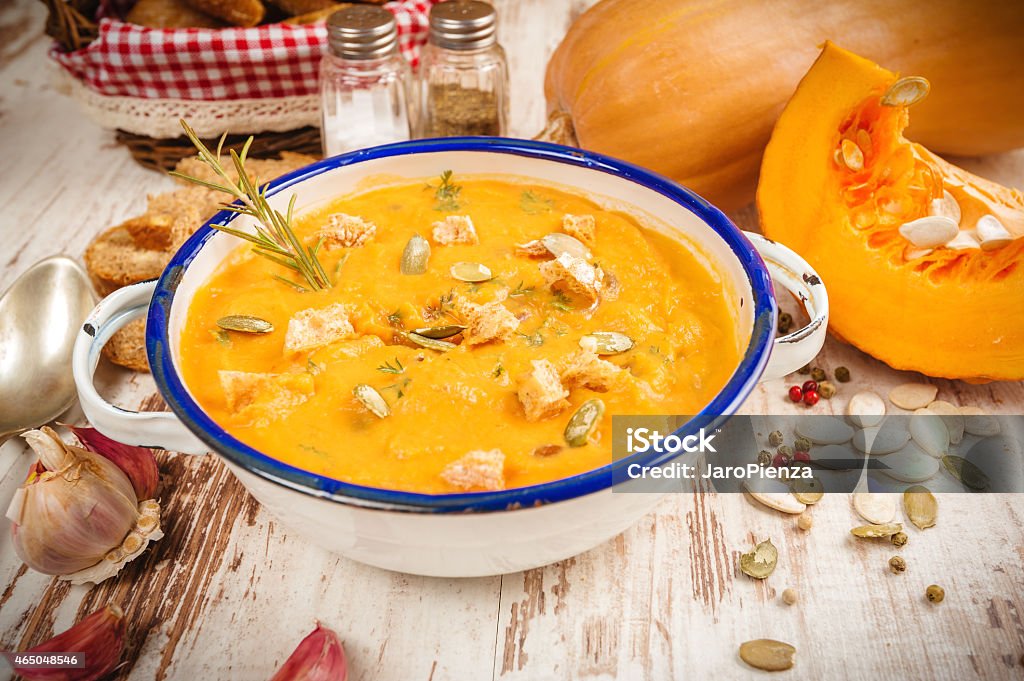 Homemade pumpkin soup in a tin bowl on rustic table Food Stock Photo