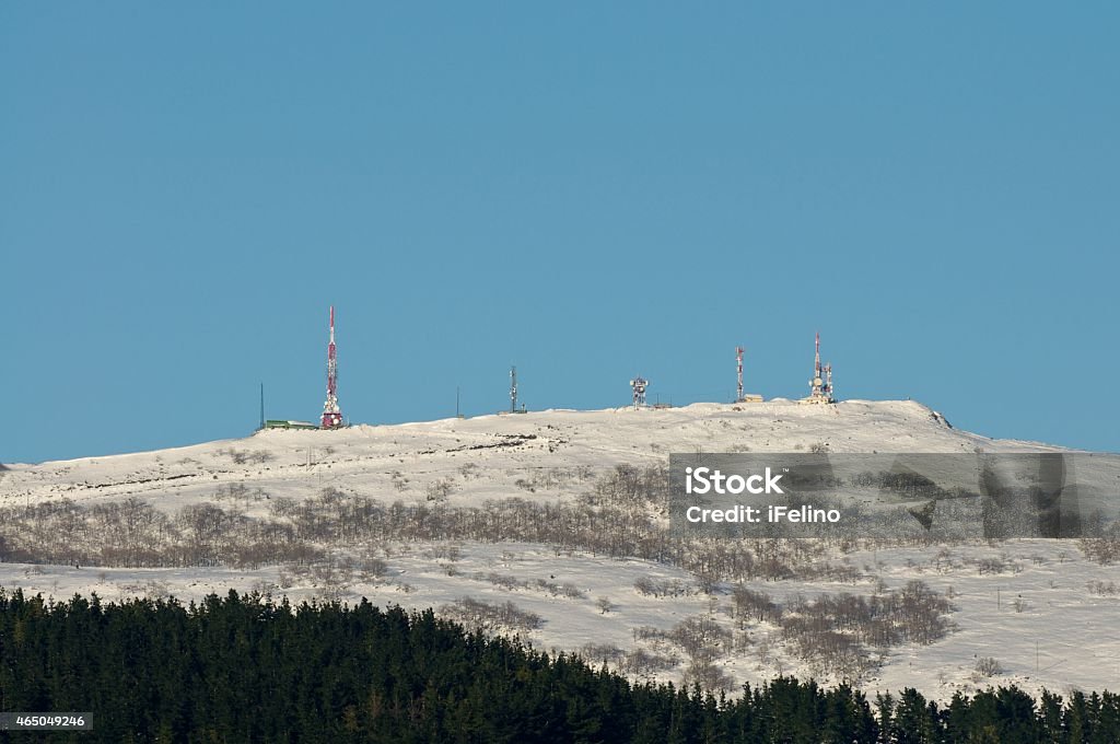 Telecommunications antennas after a snowfall Telecommunications antenna group at the summit of Mount Oiz, after a heavy snowfall (Basque Country, northern Spain). 2015 Stock Photo