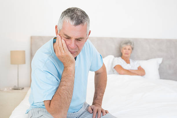 istock Disappointed senior man with woman in background 465050092