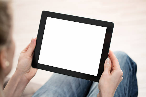 A woman is looking at a blank tablet