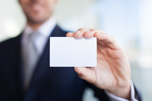 Man showing a blank business card