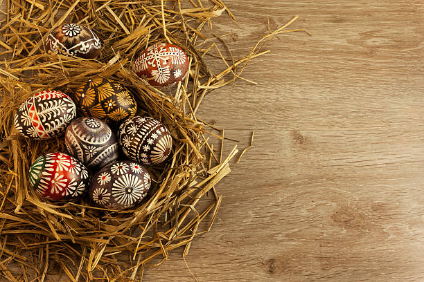 istock Easter eggs in nest on wooden background 465057852