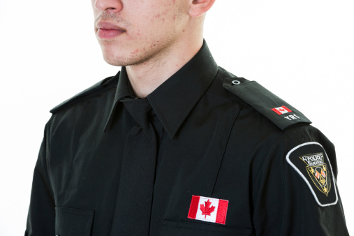 Torso of a Canadian police studen wearing uniform. Hispanic immigrant studying for becoming a policeperson.