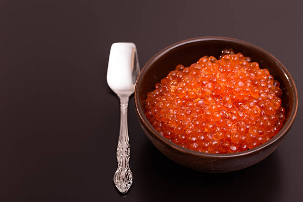 istock Bowl of red caviar and spoon 465060393