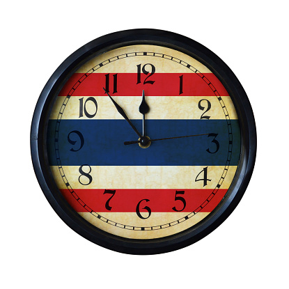 An old Thailand flag wall clock with grungy background - isolated over white.