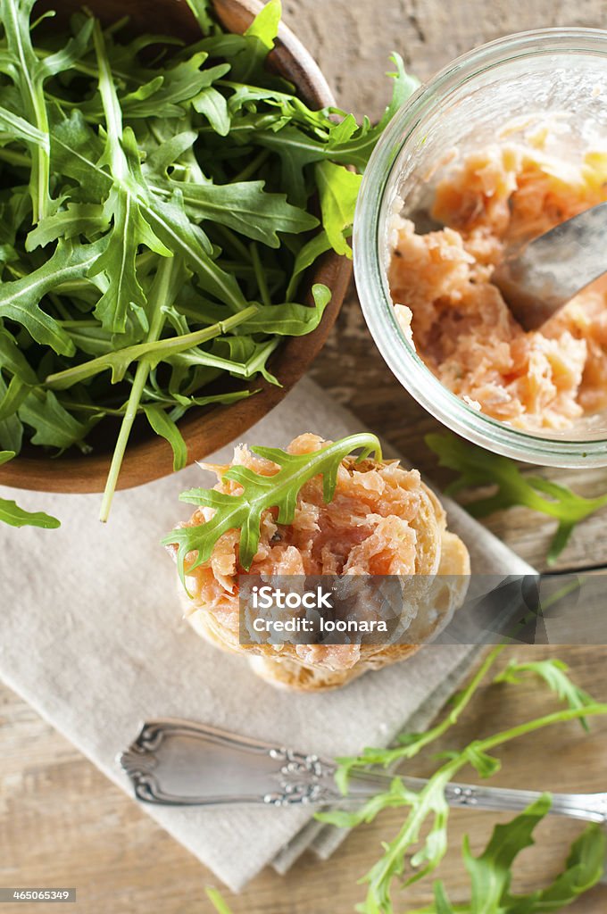 sandwiches with salmon pate Stack of sandwiches with salmon pate and arugula, fish bruschetta. Rustic homemade Italian cuisine. Appetizer Stock Photo