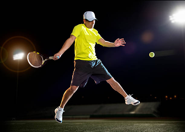 istock Tennis player at night 465066497