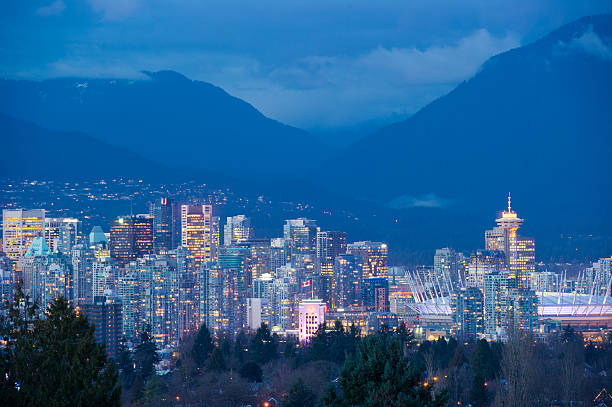 Vancouver Skyline Vancouver Skyline at dusk from Queen Elizabeth Park vancouver at night stock pictures, royalty-free photos & images