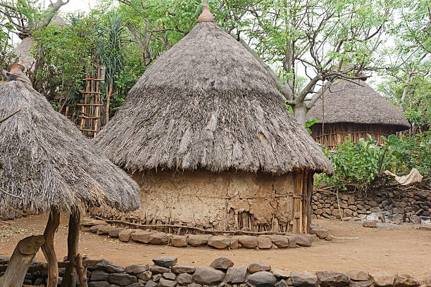 Unusual construction of mud hut in tribal village on the road between Victoria falls and Hwange National Park, western Zimbabwe, Southern Africa. Much of landlocked Zimbabwe remains undeveloped and a mix of bush with semi-fertile land with scattered forests that each occupy approx 40% of land mass. The Zambezi river forms a natural boundary with Zambia with the massive Victoria Falls forming the world's largest curtain of falling water.