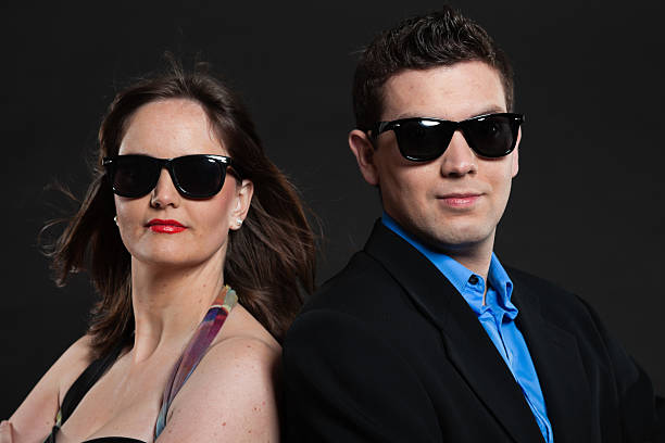 istock Happy young couple with black sunglasses. Studio shot. 465067531