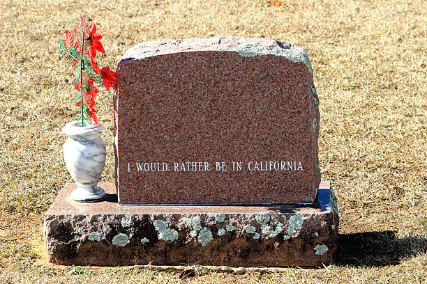 istock Humorous Tombstone or Grave Stone with red flowers 465069334