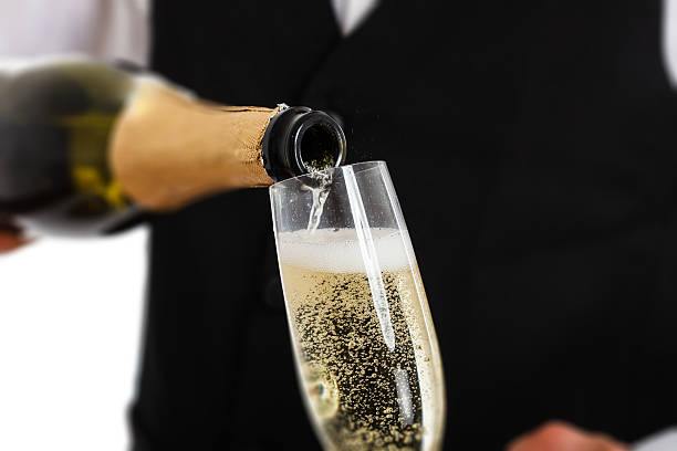 Bottle pouring champagne into flute stock photo