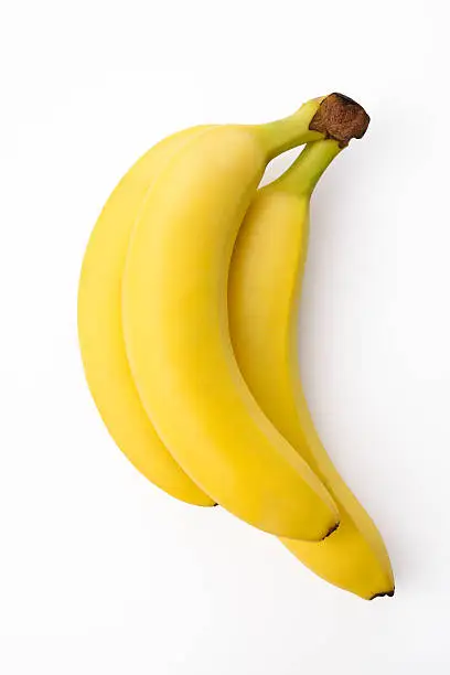 Photo of Isolated shot of bunch of bananas on white background