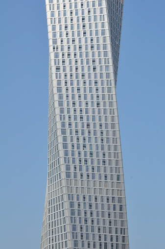 Dubai, UAE - February 20, 2014: Cayan Tower at Dubai Marina in Dubai, UAE. Also known as Infinity Tower, it is the world's tallest high rise building with a twist of 90 degrees.