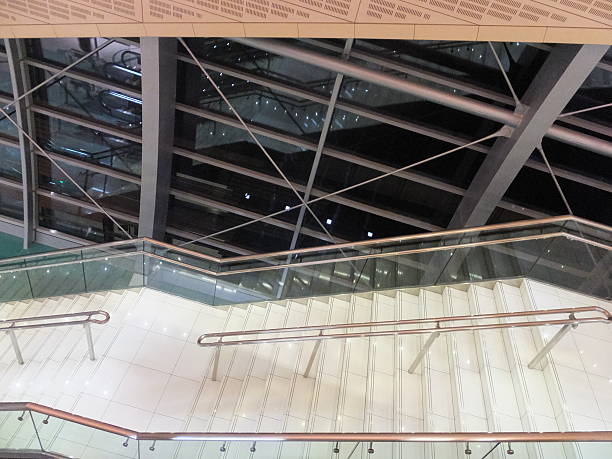 Modern glass spiral staircase with metallic handrails