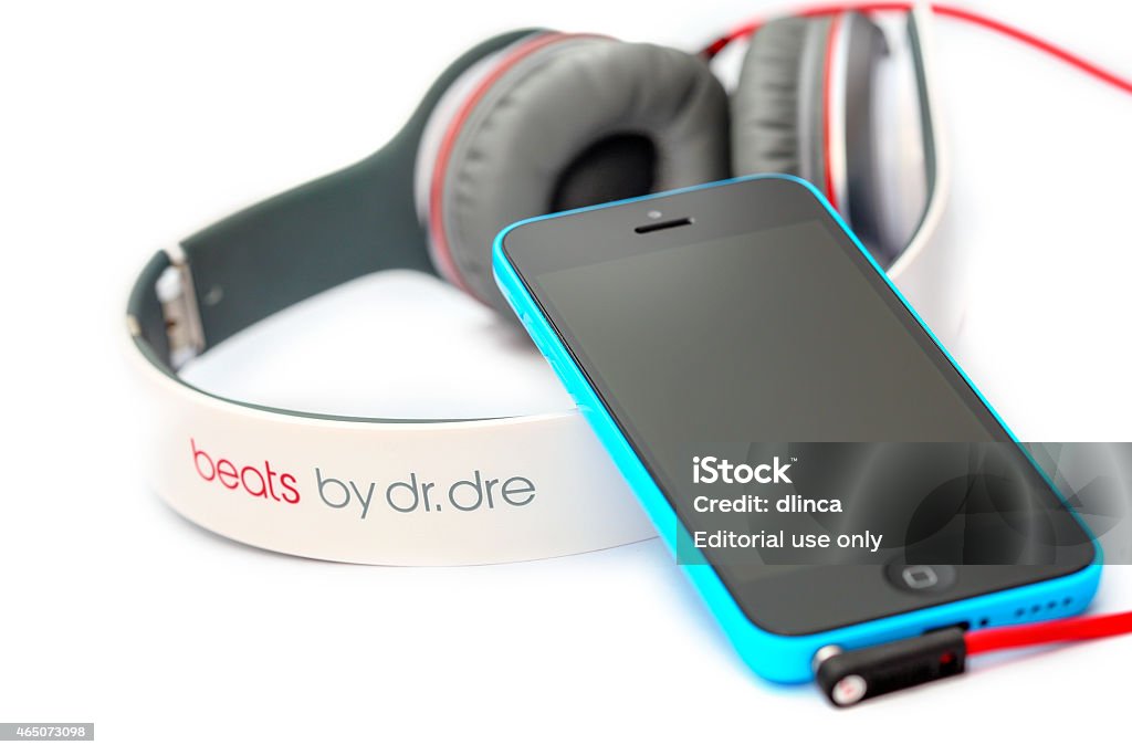 Apple iPhone 5C with Beats Headphones by Dr. Dre Placentia, CA, USA - June 2, 2014: Beats by Dr. Dre connected to an Apple iPhone 5C on white background, close up. Defeat Stock Photo