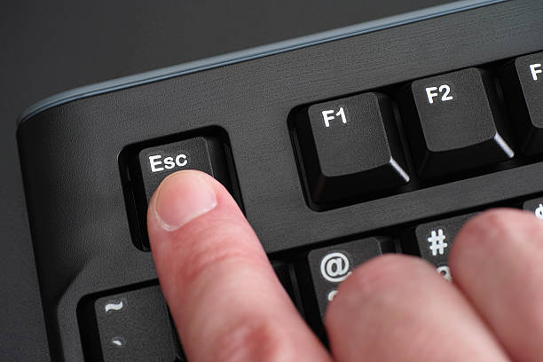 istock Finger pushing Esc key on black keyboard 465073656