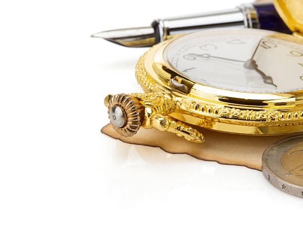 istock watch and ink pen at parchment 465075573