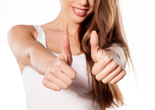 istock Happy young woman showing thumbs up 465076356