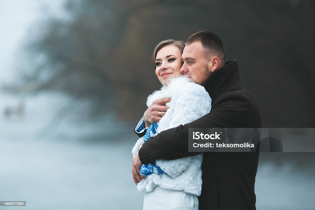 Beautiful couple on the dock in the winter fog. Beautiful couple on the dock in the winter fog.(ice preset) 2015 Stock Photo