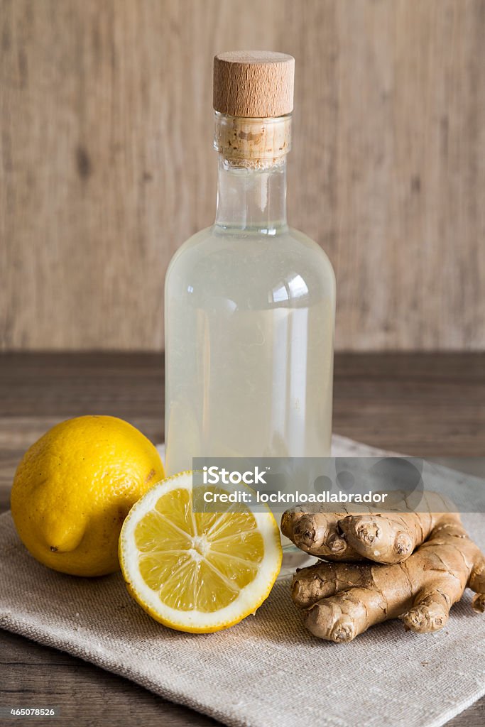 Lemon and Ginger Detox Drink in a Closed Bottle Detox lemon and ginger drink in a corked bottle. Ingredients arranged on a napkin. 2015 Stock Photo