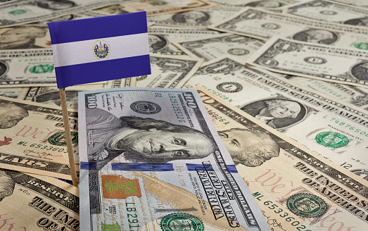 Flag of El Salvador sticking in a variety of american banknotes.(series)