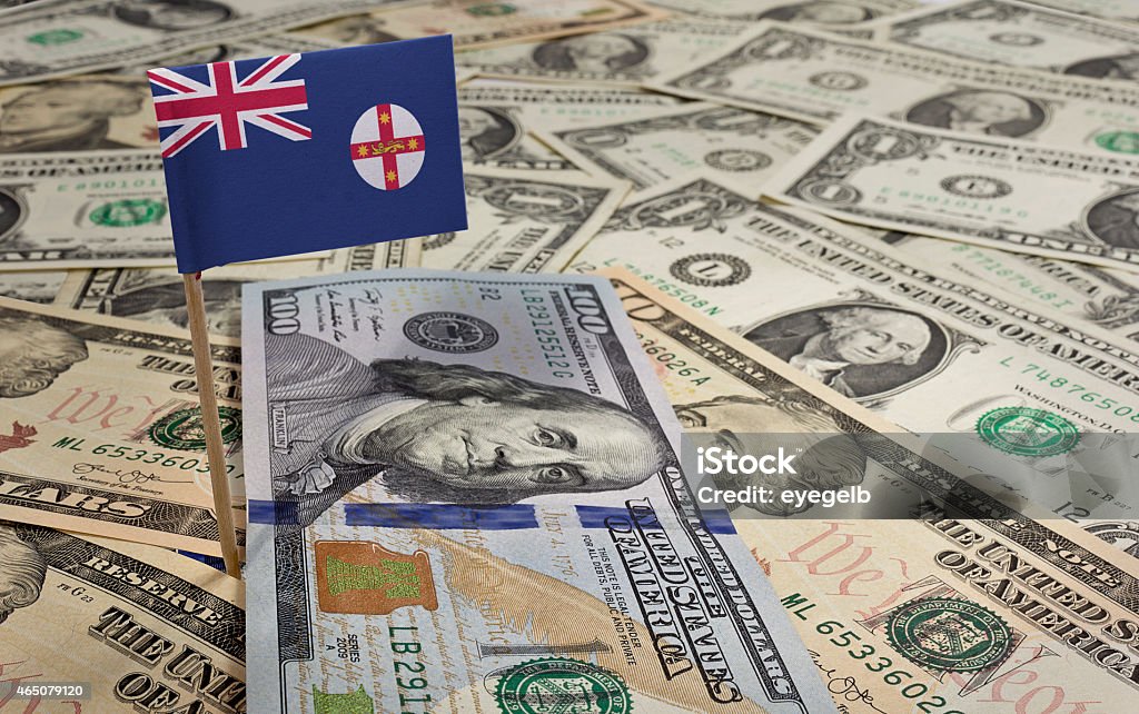 Flag of New South Wales sticking in various american banknotes.( Flag of New South Wales sticking in a variety of american banknotes.(series) 2015 Stock Photo