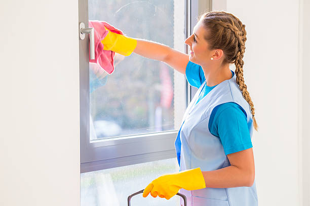 istock Cleaning lady with cloth at window 465080110