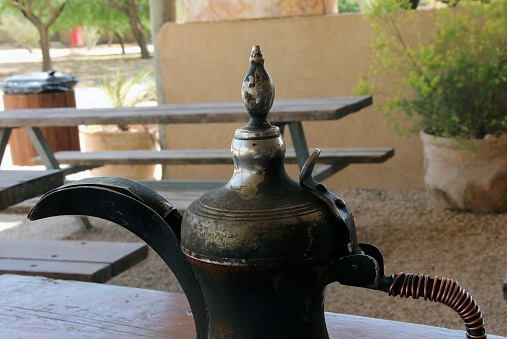 Traditional old arabic coffee pot  on the wooden table