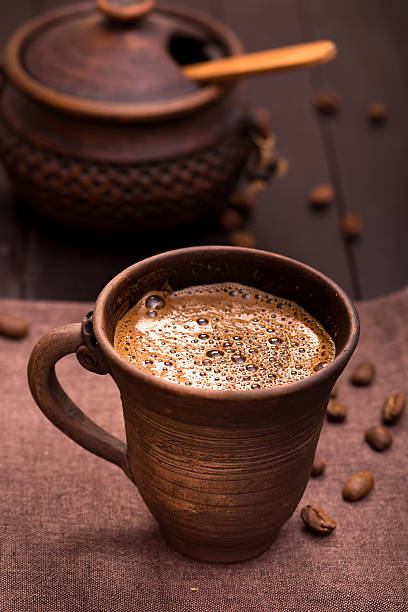 istock Pottery cup of coffee on a napkin 465081193
