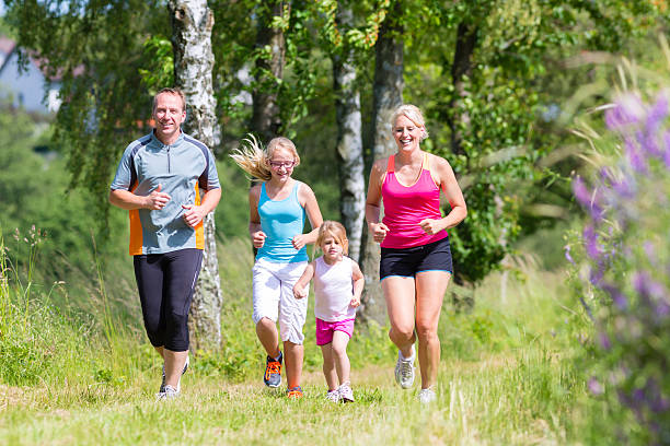 istock Family sport jogging through field 465081706