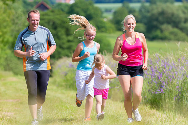 istock Family sport jogging through field 465081714