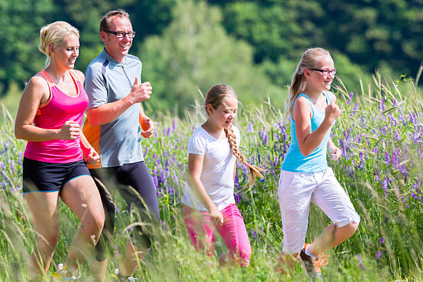 istock Family sport jogging through field 465081718