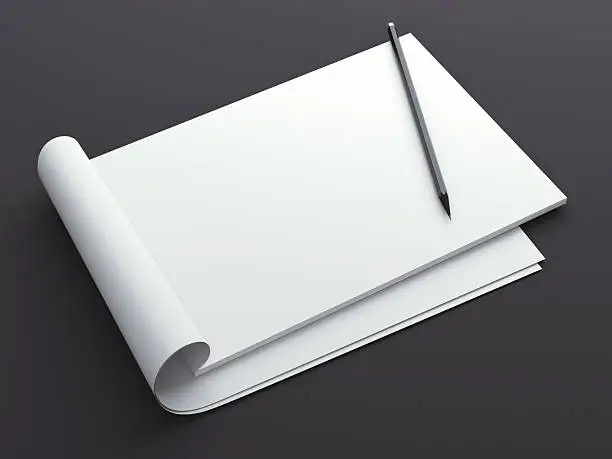 Blank sketchbook with pencil isolated on a black background. 