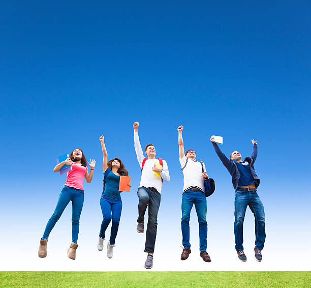 istock Happy young group of students jumping together 465083956