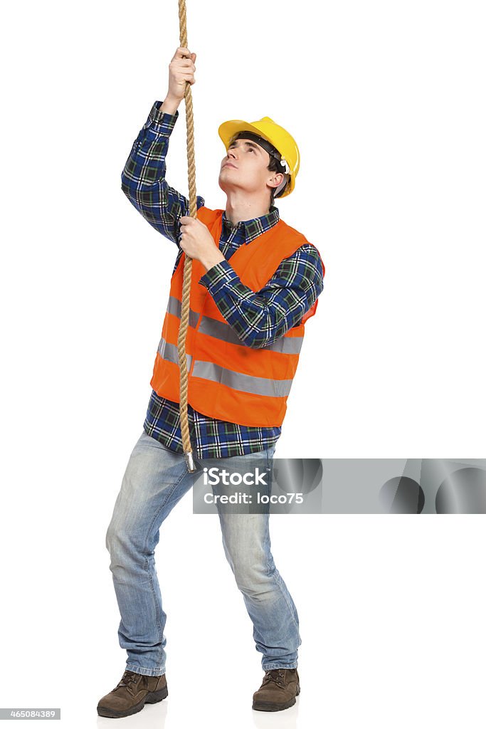 Worker Puling Rope Construction Worker Pulling A Rope Stock Photo - Download Image Now ...