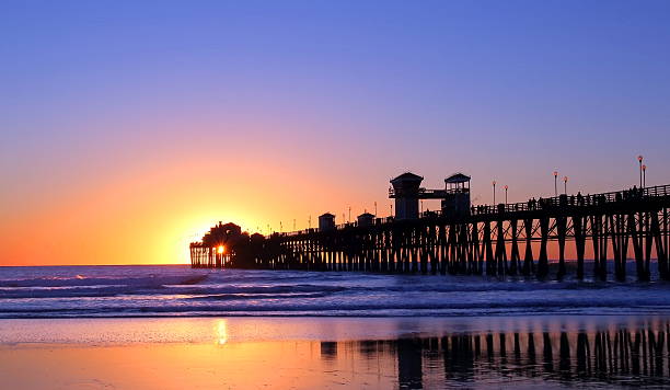 istock A pier at low tide with sunset behind 465085524