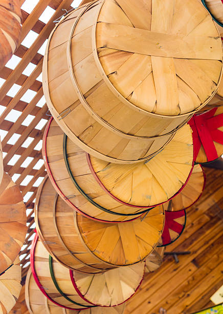 istock Woven wooden baskets hanging up in barn 465087018