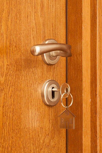 istock door handle with key in the keyhole and house icon 465087466