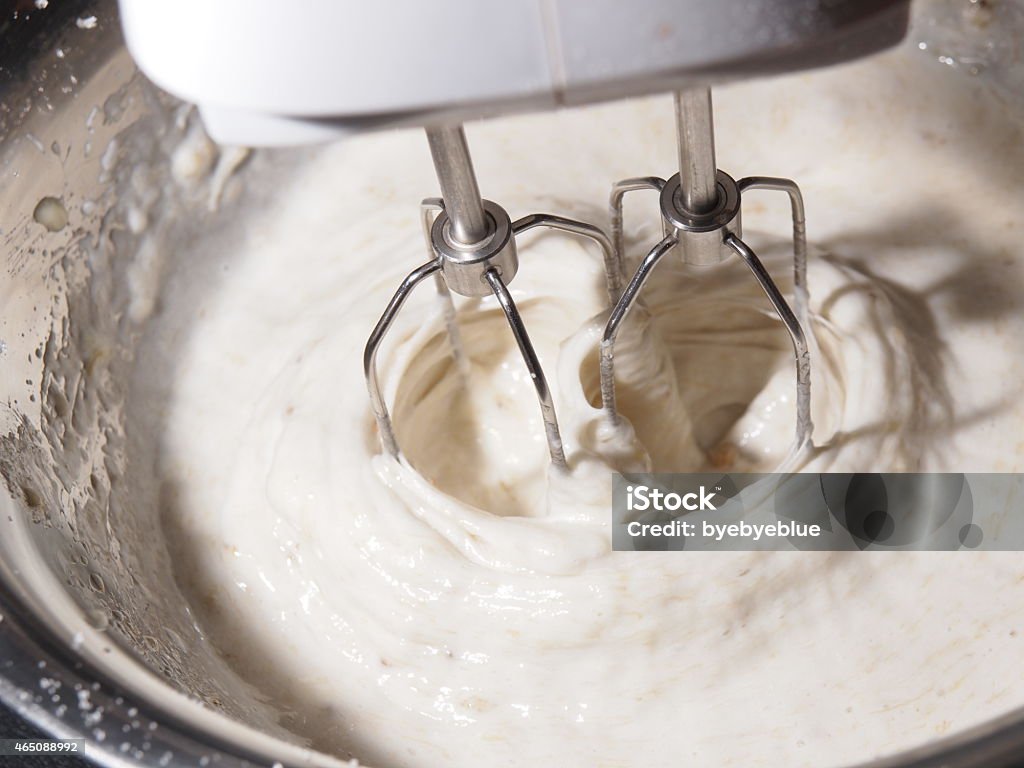 Mixing butter sugar and egg yolk with mixing machine Mixing egg, banana, cake flour in bowl with motor mixer, baking banana cake 2015 Stock Photo