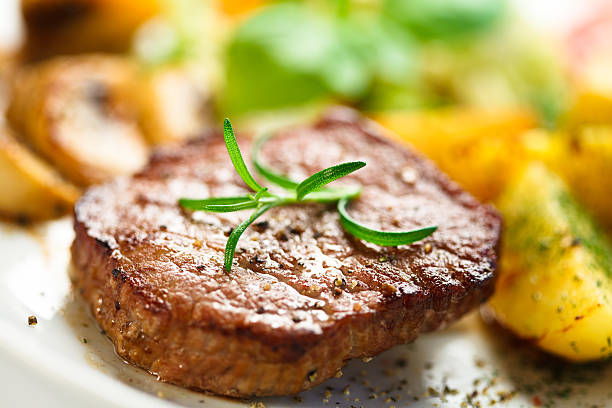istock Grilled steak, baked potatoes and vegetables on white background 465090416