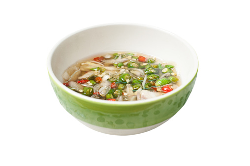 Fish sauce with chilli, garlic and shallot in a bowl isolated on white blackground.