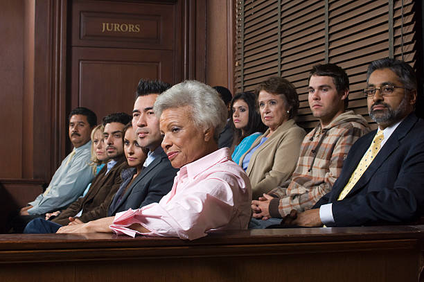 A diverse group of people sitting in a courtroom  stock photo