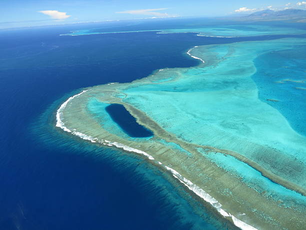Coral Reef - Lagoon New Caledonia Coral reef, pass and Trou d'Oundjo seen from ULM - Lagoon New Caledonia atoll photos stock pictures, royalty-free photos & images