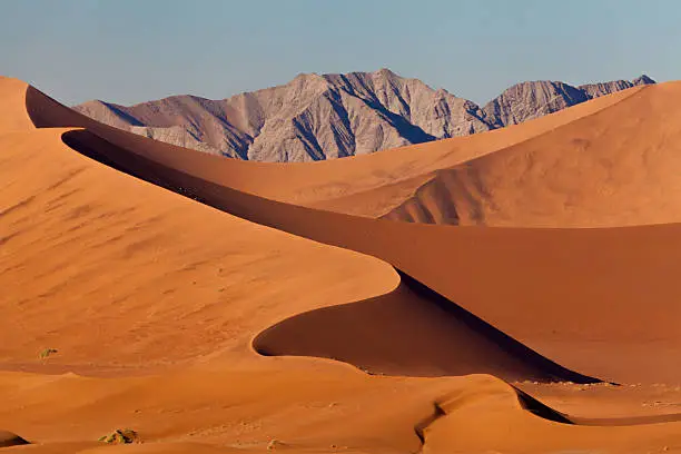 View to sand dunes and mountains at the famous landmark Sossusvlei, Namib Desert, Namib Naukluft Park, Namibia
